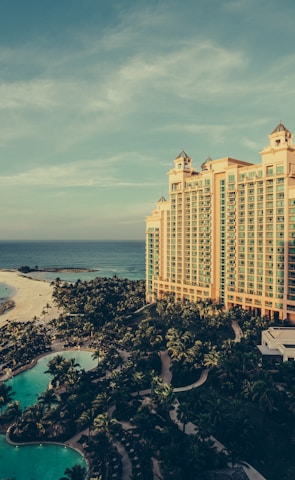 yellow concrete building beside body of water