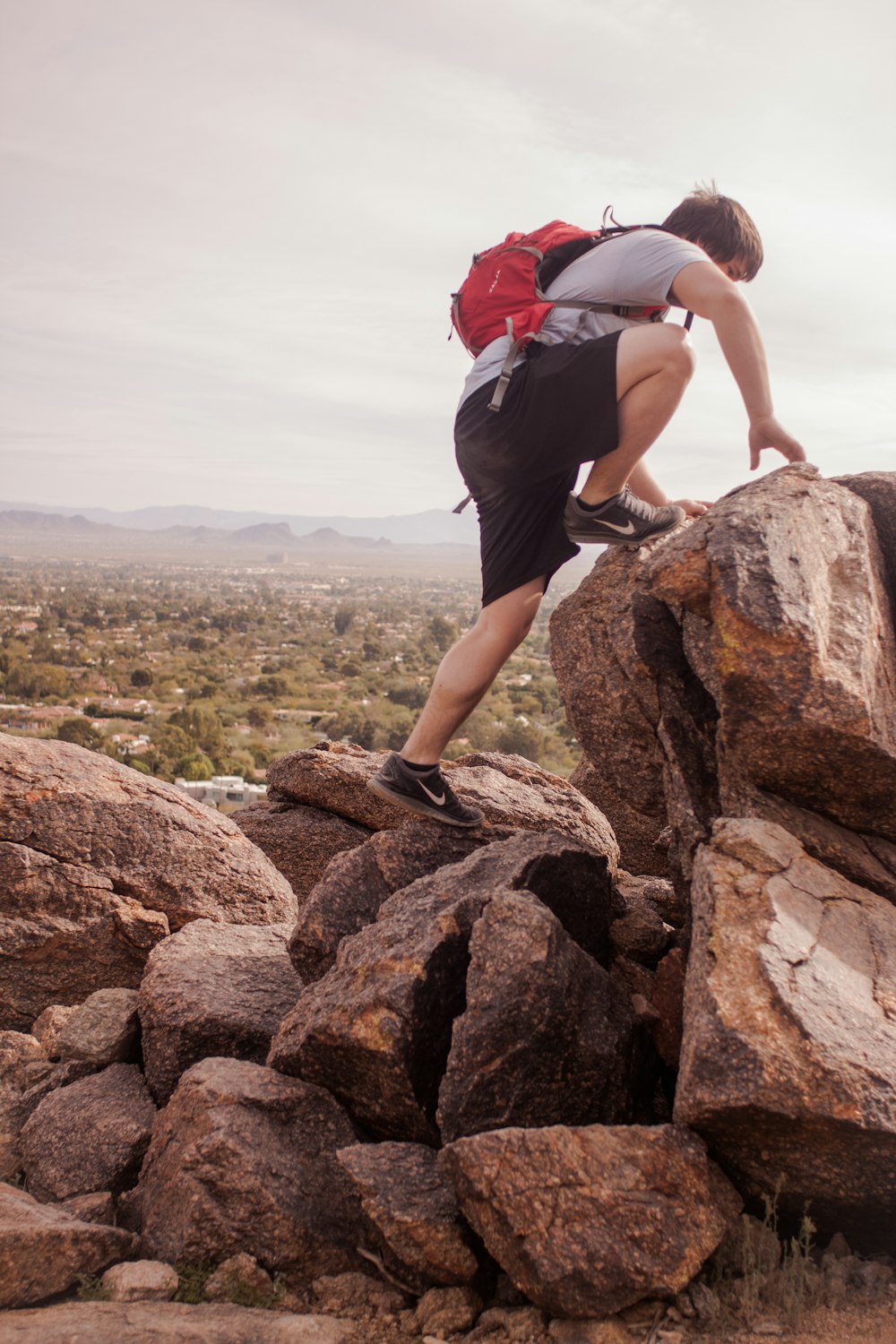 man climbing mountain