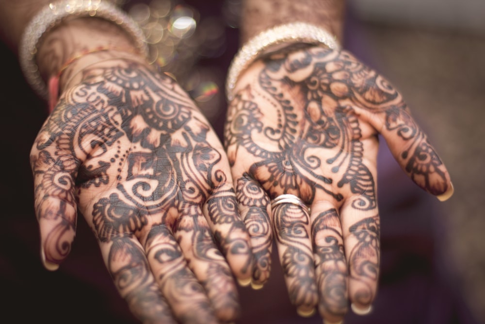 person showing hand tattoos