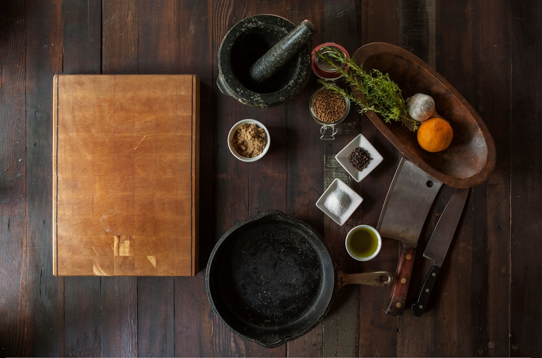  black mortar and pestle beside brown box in top view photography pestle