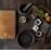 black mortar and pestle beside brown box in top view photography