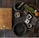 black mortar and pestle beside brown box in top view photography