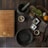 black mortar and pestle beside brown box in top view photography