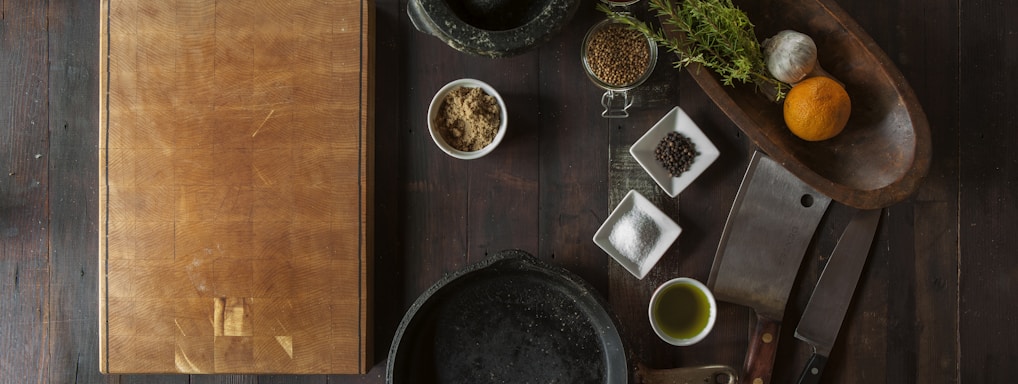 black mortar and pestle beside brown box in top view photography