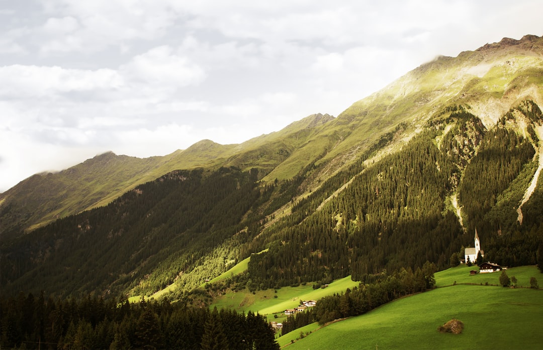 green mountains and trees under white cloudy sky during daytime,