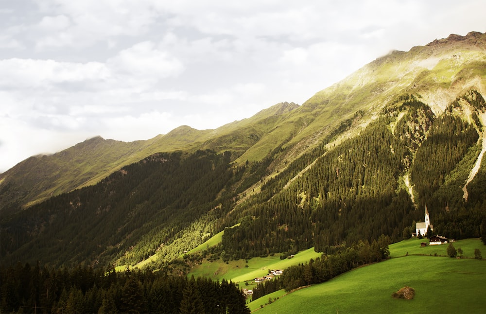 green mountains and trees under white cloudy sky during daytime