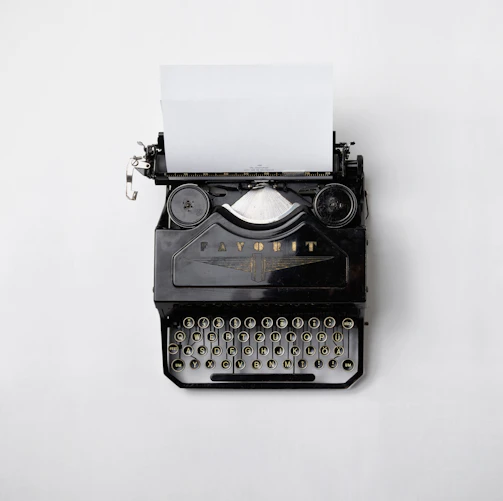 black Fayorit typewriter with printer paper