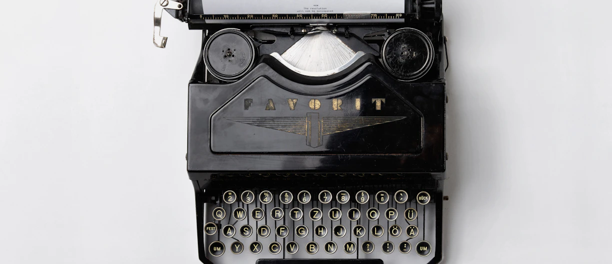 black Fayorit typewriter with printer paper