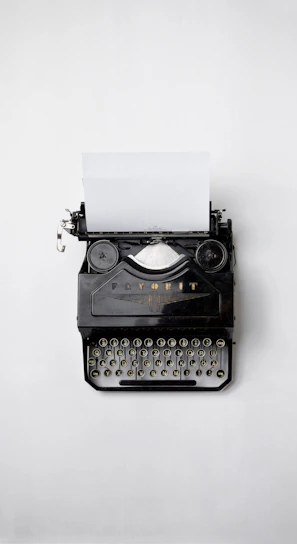 black Fayorit typewriter with printer paper