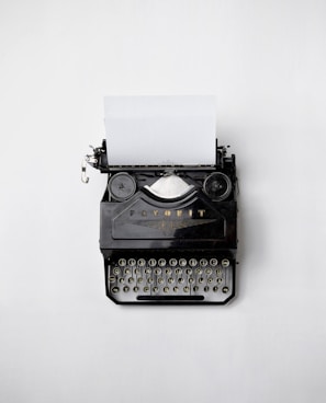 black Fayorit typewriter with printer paper