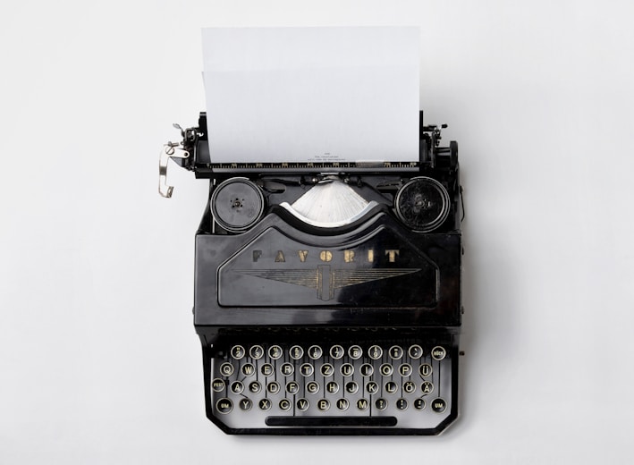 black Fayorit typewriter with printer paper