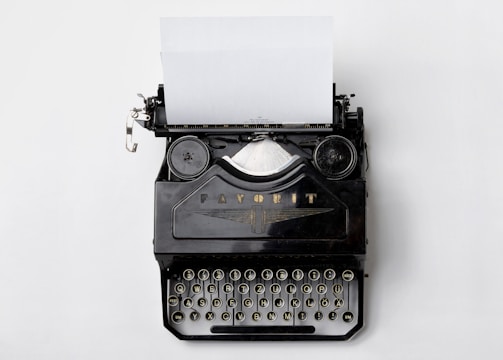 black Fayorit typewriter with printer paper