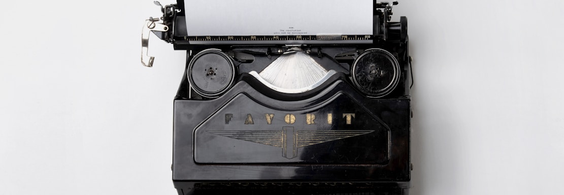 black Fayorit typewriter with printer paper