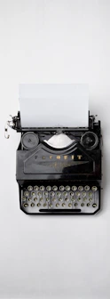 black Fayorit typewriter with printer paper