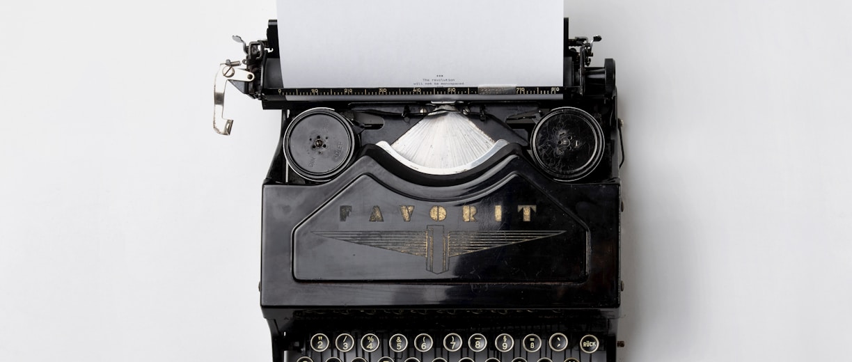 black Fayorit typewriter with printer paper