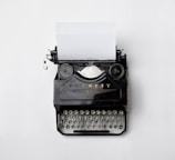 black Fayorit typewriter with printer paper