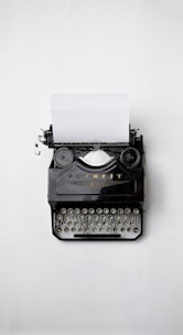 black Fayorit typewriter with printer paper