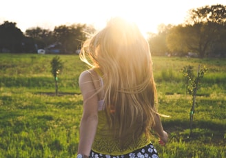 woman walking on lawn with trees