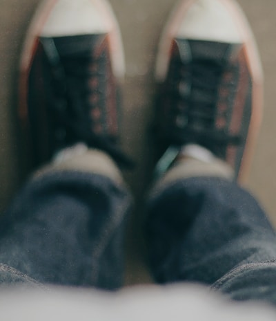 person wearing white-and-black low-top sneakers