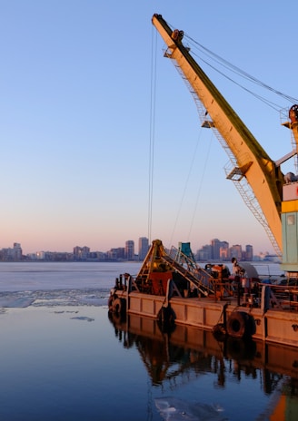 yellow and blue commercial machine near body of water