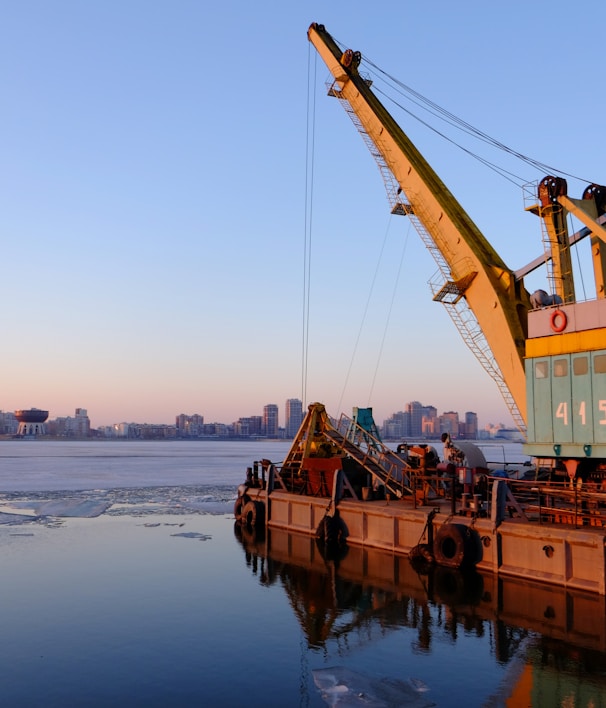 yellow and blue commercial machine near body of water