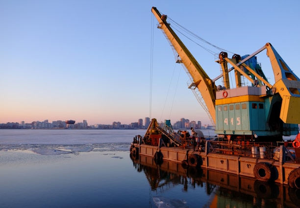 yellow and blue commercial machine near body of water