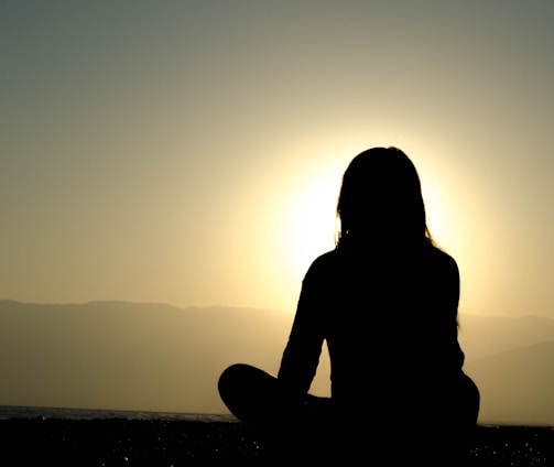 woman sitting on sand