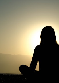 woman sitting on sand
