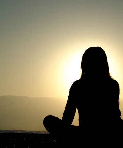 woman sitting on sand