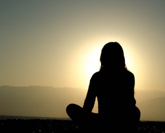 woman sitting on sand