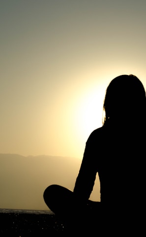 woman sitting on sand