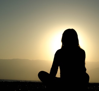 woman sitting on sand