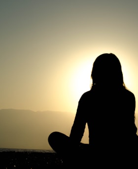 woman sitting on sand