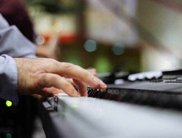 selective focus of person playing piano