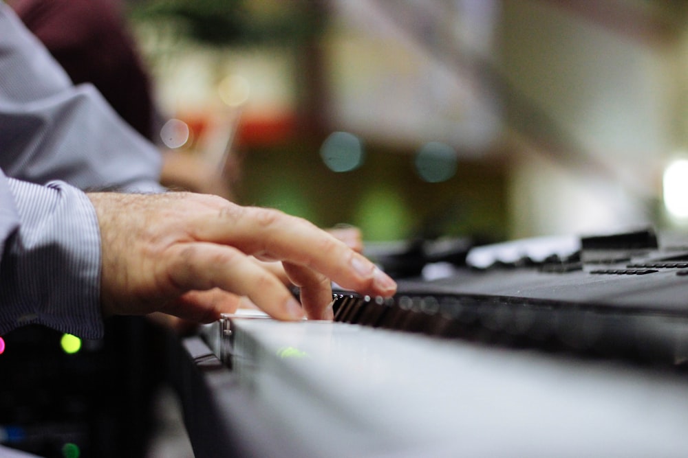selective focus of person playing piano