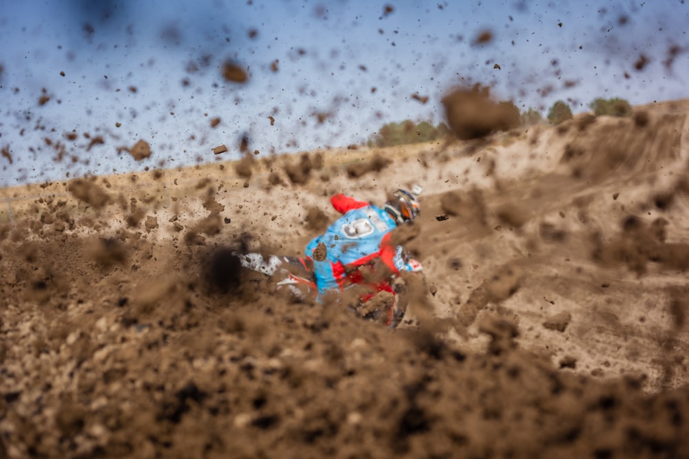 Fotografía de enfoque selectivo de hombre montando motocicleta en camino de tierra