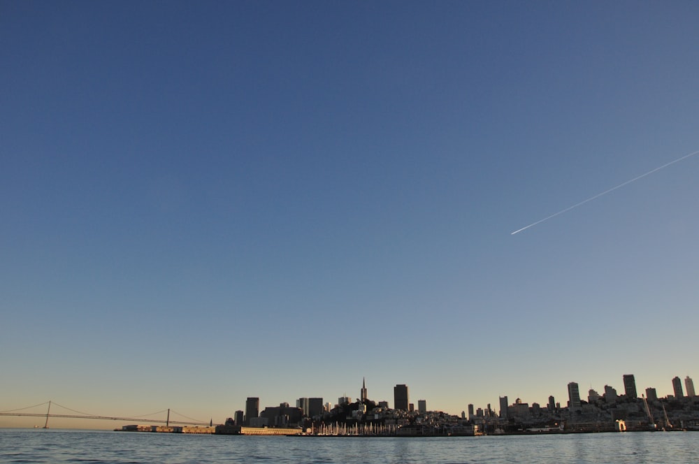 shooting star can be seen through city during daytime