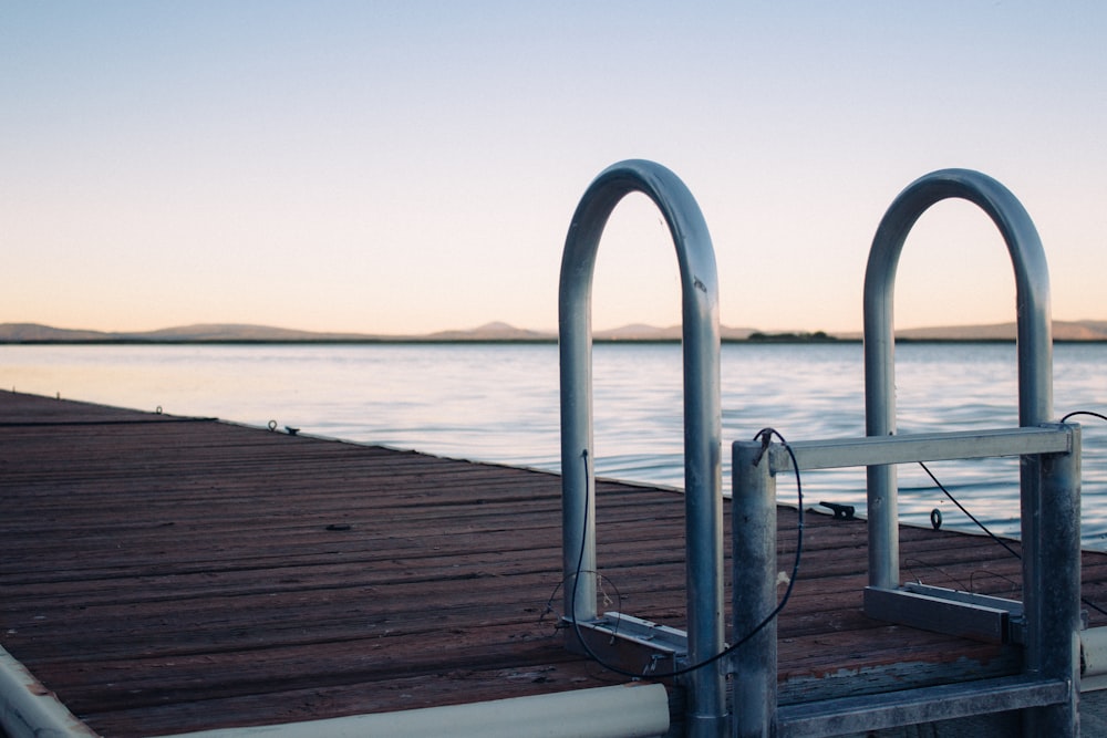 a wooden dock with two metal railings on it