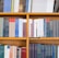 A bookshelf filled with a variety of academic and professional books, arranged neatly in rows. The spines display titles in different languages and cover various topics. Some books are thicker, while others are thinner, showing diversity in publishing styles.