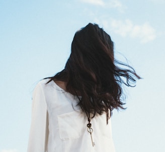 woman in white shirt under cloudy sky