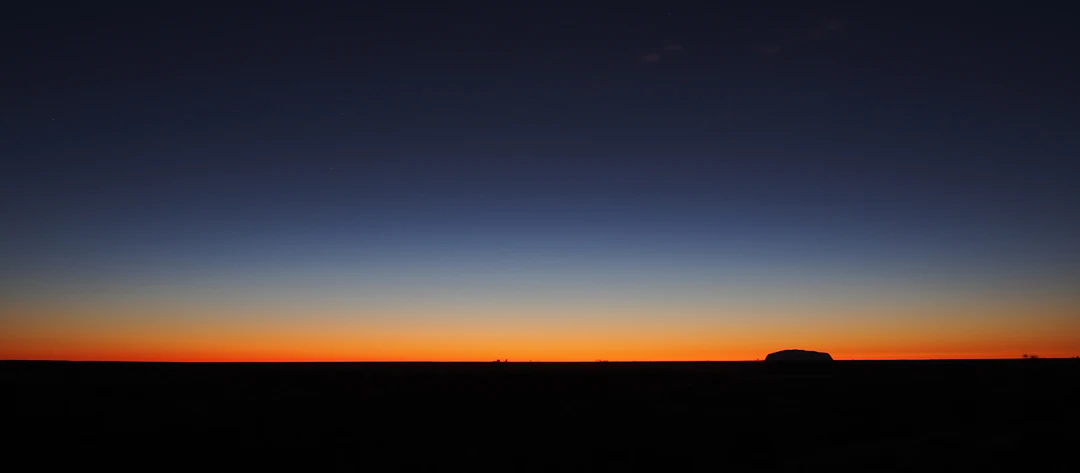 First light of dawn breaking over a quiet horizon