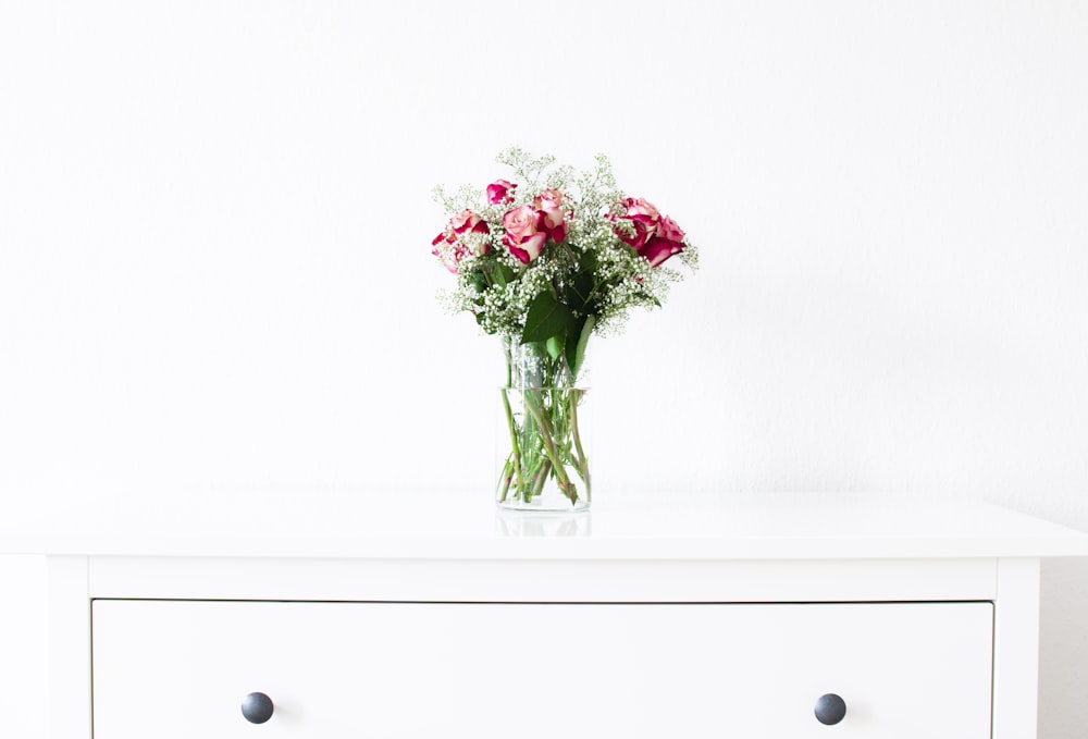 red rose in clear glass vase