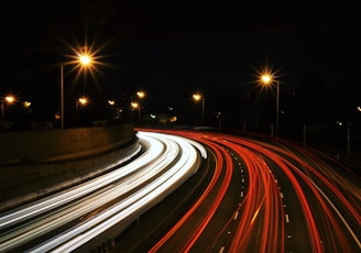 time-lapse photography of highway road at night