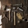 clothes iron, hammer, axe, flashlight and pitcher on brown wooden table