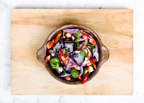 sliced onions and bell pepper in a bowl