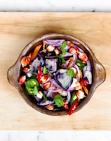 sliced onions and bell pepper in a bowl
