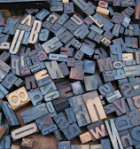 Collection of different ligature designs displayed on a modern wooden surface