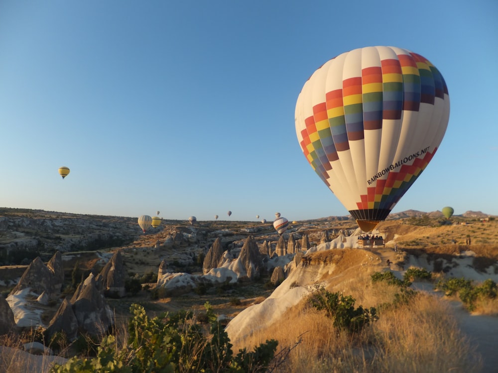 hot air balloons in flight above mountains