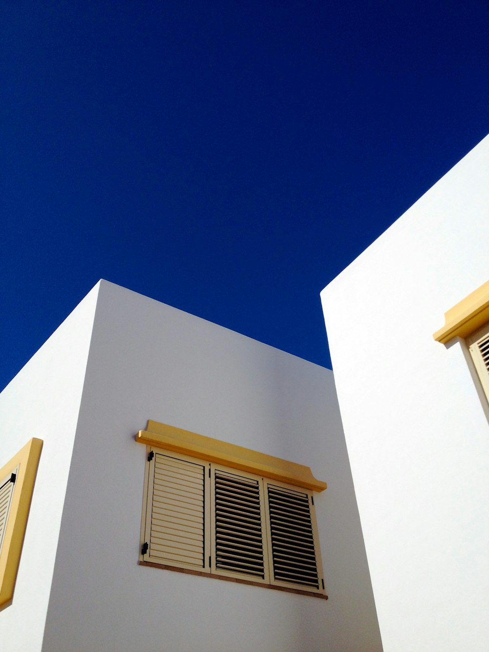 low angle photography of brown louver window