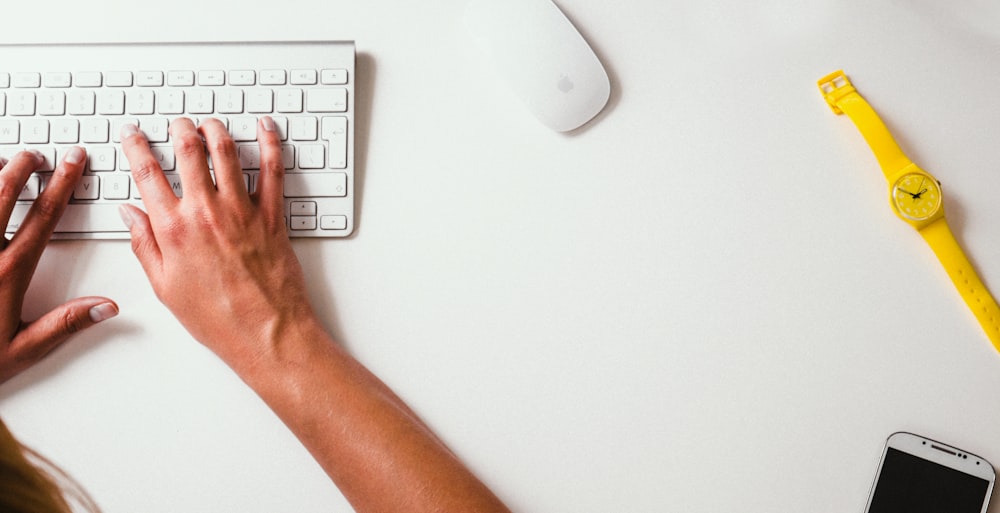 person typing on Apple Cordless Keyboard